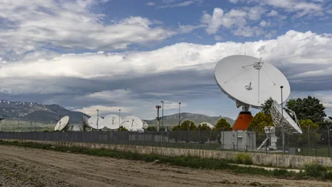 Timelapse of satellite dishes and clouds with mountain landscape Stock Footage 154598376