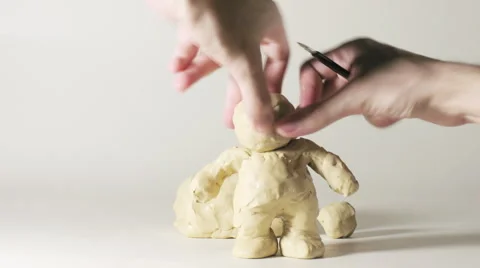 Timelapse sculptor modeling plasticine comic figure of man in hat Stock Footage 1049589