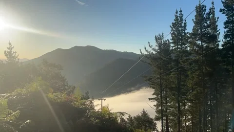 Timelapse of a sea of clouds coming down the mountain in the early morning Stock Footage 254189071