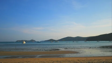 Timelapse of sea wave breaking sand beach coast, yacht parking middle sea , m Stock Footage 127734016