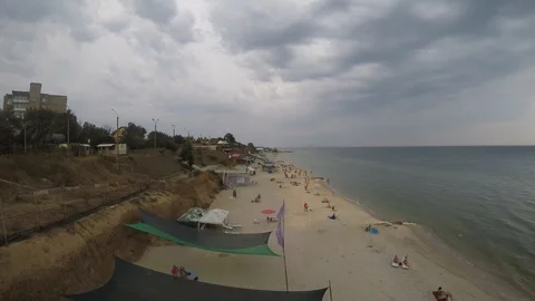 Timelapse of the seashore, clouds slowly float across the sky, people walking Stock Footage 122646316