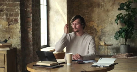 Timelapse of serious young man using computer for research and creative work. Video stock 156938154