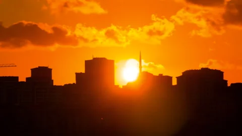 Timelapse: setting sun hiding behind Istanbul silhouettes and moving clouds Stock Footage 341278112