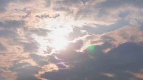 Timelapse: setting sun hiding behind fast clouds with lens flare Stock Footage 341294878