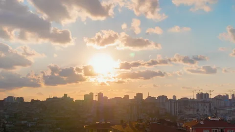 Timelapse: setting sun rays through fast clouds over Istanbul rooftops Stock Footage 341278916