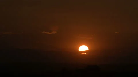 Timelapse of the setting sun at sunset over a small town. Low key Stock Footage 114270620