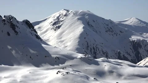 Timelapse shadows move across snowy hillside - Mountain Chain and Alpine Slopes Stock Footage 339814039