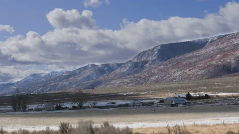 Timelapse-Shadows pass over valley ranch-Clouds stream over mountai Vídeo Stock 143163468