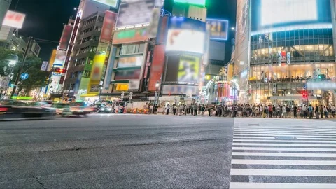 Timelapse of Shibuya Crosswalk Ground Level at Night -Pan Right- Stock Footage
