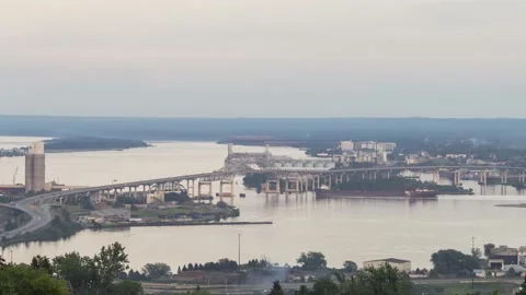 A Timelapse of a Ship Passing under the Blatnik Bridge at Sunset in Duluth, MN Video stock 144396621