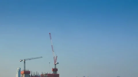 Timelapse shot of Construction cranes while building the highrise skyscraper  Stock Footage 198309066