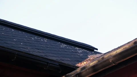 Timelapse shot of man sweeping dried leaves on a roof Stock Footage 56610835