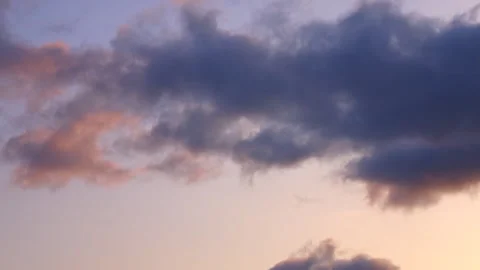 Timelapse shot of the movement of clouds at sunset. Pink sky at magic hour. 4K Stock Footage 306433755