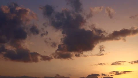 Timelapse shot of the movement of clouds at sunset. Gold sky at magic hour. 4K Stock Footage 306433864