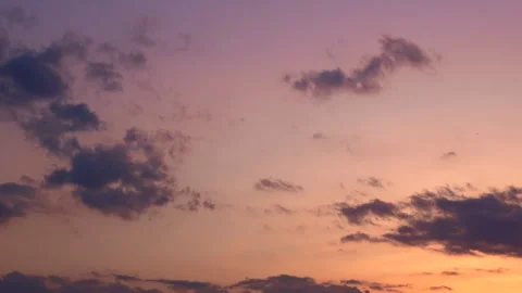 Timelapse shot of the movement of clouds at sunset. Pink sky at magic hour. 4K Stock Footage 306563954