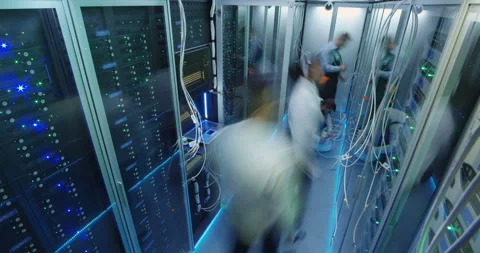 Timelapse shot of people working in a data center with Stock Footage 98010257