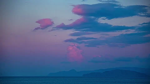 Timelapse shot of red cumulus clouds exploding at background with a smoky Stock Footage 286075714