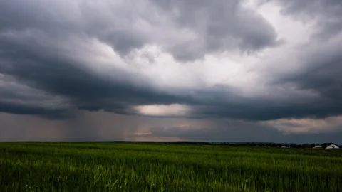 Timelapse showing dark storm clouds approaching with rainfall. Stock Footage 301426636