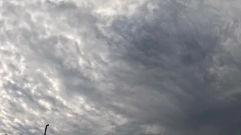 Timelapse showing the dynamic and powerful movement of dark, grey storm clouds Stock Footage 331046857