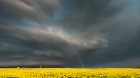 A timelapse showing a supercell storm with dynamically moving clouds and rainbow Stock Footage 301406003