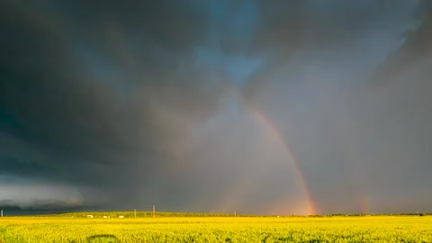 A timelapse showing a supercell storm with dynamically moving clouds and rainbow Stock Footage 301432877