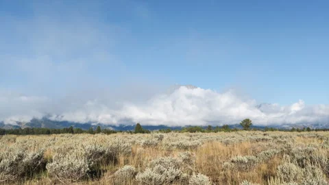 Timelapse Showing Swirling Clouds rushing to the Base of the Grand Tetons Stock Footage 258195341