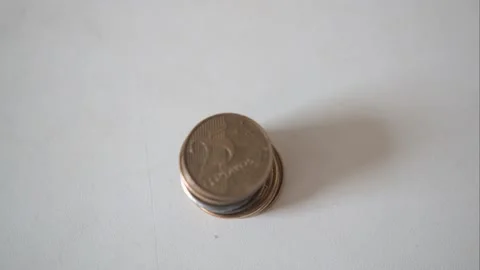 Timelapse of a single stack of Brazilian real coins being put in a table Stock Footage 160359221