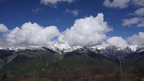 Timelapse of a ski lift on a background of mountains and clouds Stock Footage 79136332