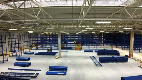 Timelapse skilled workers build and fix metal rack carcass with drills in light Stock Footage 122370336