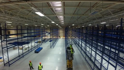 Timelapse skilled workers build and fix metal rack carcass with drills in light Vidéo 122370388