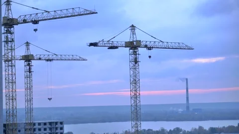 Timelapse of the sky against the background of cranes and a factory Stock Footage 144145431