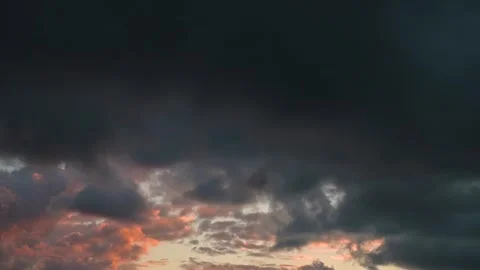 Timelapse sky undergoes a transformation, shifting from bright sunset hues to Stock-Footage 338300226