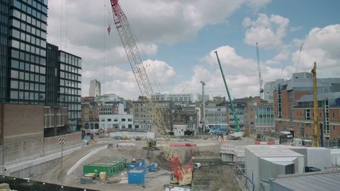 Timelapse of a skyscraper construction site with cranes, sun and clouds passing Stock Footage 128782053