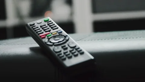 Timelapse of a smart TV remote control with colorful light from TV screen Stock Footage 107862707