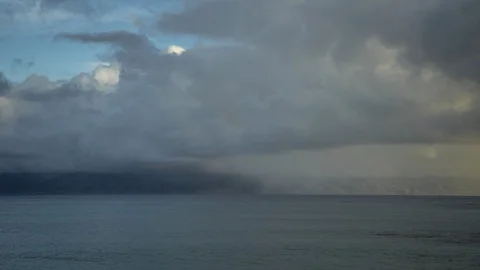Timelapse of Smoothly Moving Clouds and Rain Over Maui and Molokai Stock Footage 129049148
