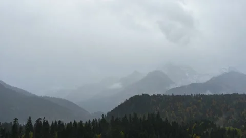Timelapse snow capped mountain peaks. Rain, fog, cyclone in the mountains Stock Footage 226962767