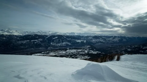 Timelapse of snow cloud travelling across sky above mountains and Engelberg city Stock Footage 129100002