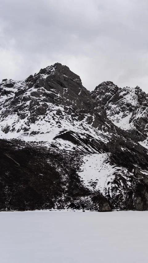 Timelapse of Snow-Covered Peaks and Frozen Lake in Qizang Gou Stock Footage 346168063
