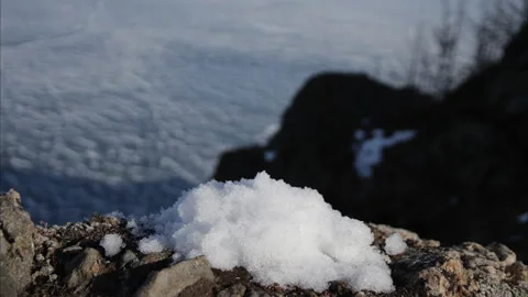 Timelapse of snow melts on a rock. Video stock 114461084