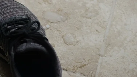 Timelapse: Snow melts into slush and water next to a sneaker brought inside Stock Footage 102907161