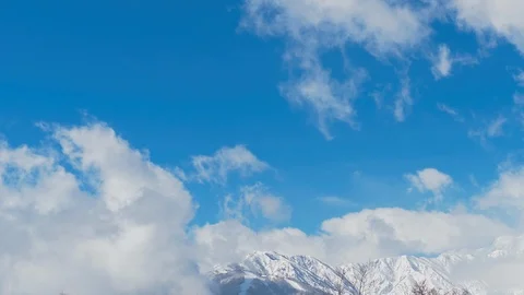 Timelapse of snowy mountains and clouds in Nagano, Japan : Pan Stock Footage 105654053
