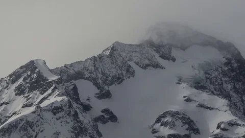 Timelapse with snowy peaks, white clouds passing over at high speed Stock Footage 69831785