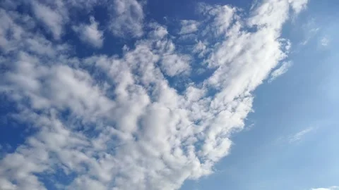 Timelapse of soft beautiful white cumulus clouds move in the blue sky Stock Footage 285732011