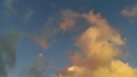 Timelapse of soft golden sunset clouds drifting across a darkening sky Stock Footage 344752013
