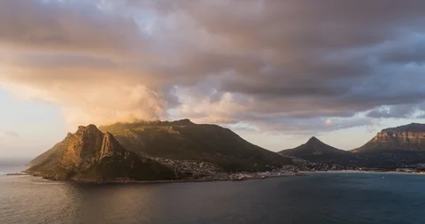 Timelapse of some big clouds blowing over Chapmans Peak Mountain during sunset Video stock 126964687