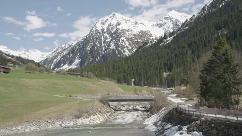 Timelapse Spectacular mountain valley with a rushing river, lush green meadows, Stock-Footage 334655815