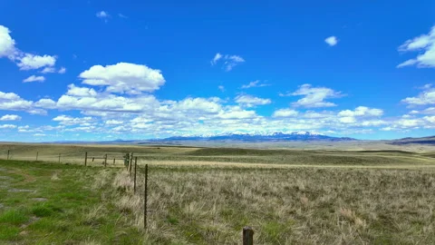 Timelapse - Sping clouds mountains to dirt road Stock Footage 308667044