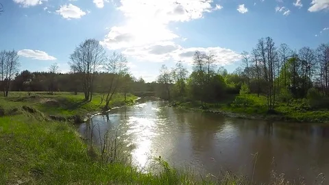 Timelapse spring nature. The flow of the river and clouds in the sky. Stock Footage 83887699