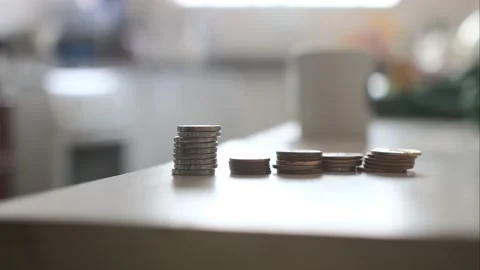 Timelapse of a stack of Brazilian real coins being put in a table Stock Footage 160359706