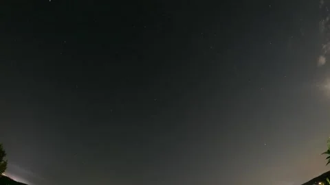 Timelapse of Starry Night Sky with Fast Moving Clouds, Glowing Moon and Stars Stock Footage 343806388